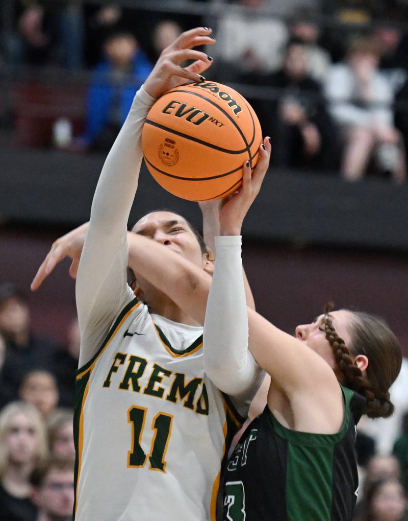 Fremd’s Coco Urlacher, left, draws a foul on a shot by Glenbard West's Mya Austin during the Hersey Class 4A supersectional at Forest View Education Center on Monday, March 3, 2025 in Arlington Heights.