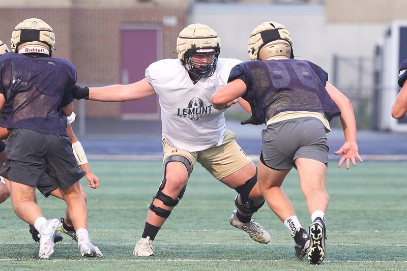 Lemont’s Jake Sulzberger makes a block during football practice on Wednesday, July 24, 2024.