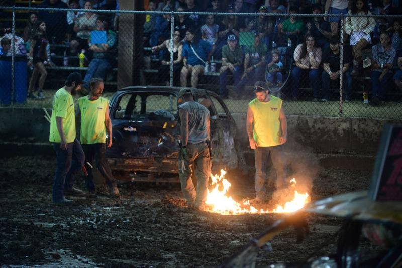 Track officials burn off gas after it leaked from a car on to the track during a stop in the action in the Compact Heat at the Ogle County Fair's demolition derby on Saturday, Aug. 2, 2025.