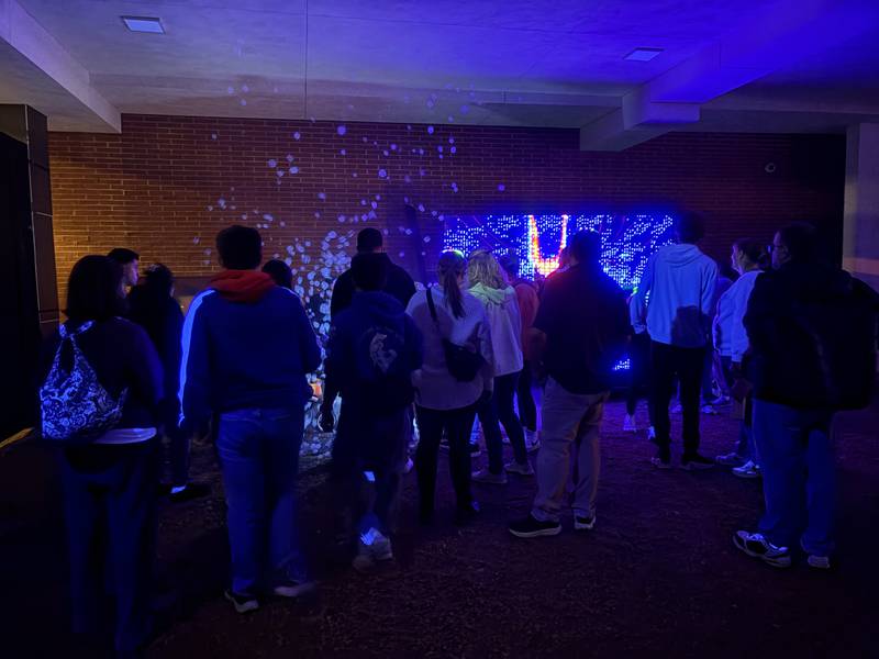 People explore Lumenaura, an array of light installations which run through Oct. 26, 2025, in downtown Aurora.