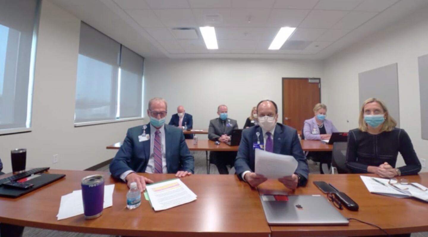 Chief medical officer at Northwestern Medicine Dr. Irfan Hafiz, middle, speaks to members of the Illinois Health Facilities and Services Review Board Tuesday, Dec. 14, 2021.