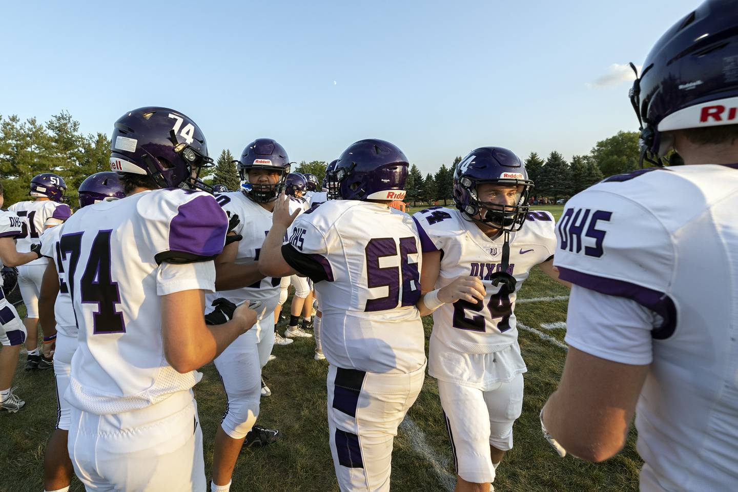 The Dixon sideline celebrates an opening kickoff touchdown by Tyson Dambman Friday, August 25, 2023 against Stillman Valley.