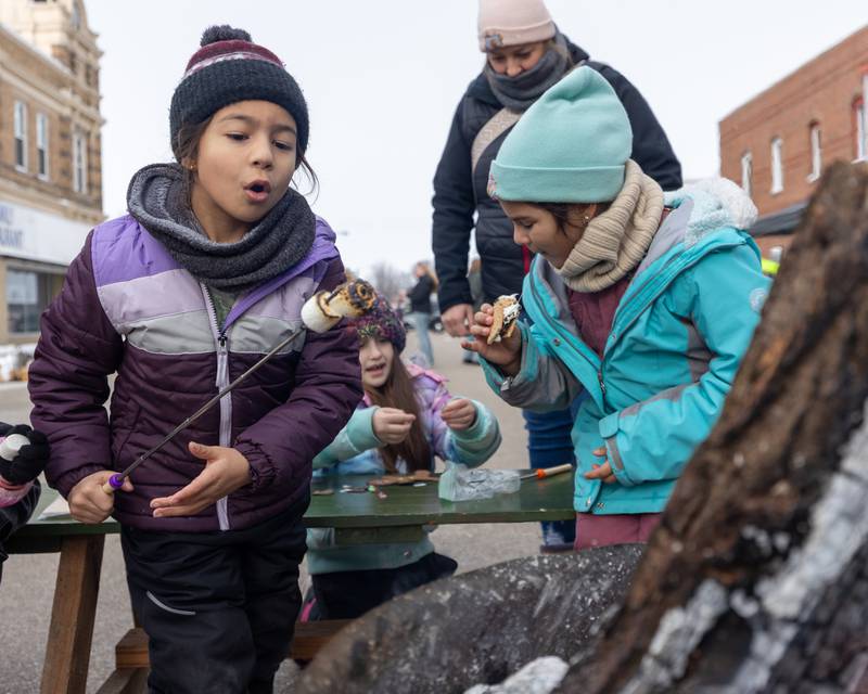 Amelia Rosales blows out fire on Marshmello on Saturday, December 6, 2025 on Illinois Avenue in Mendota.