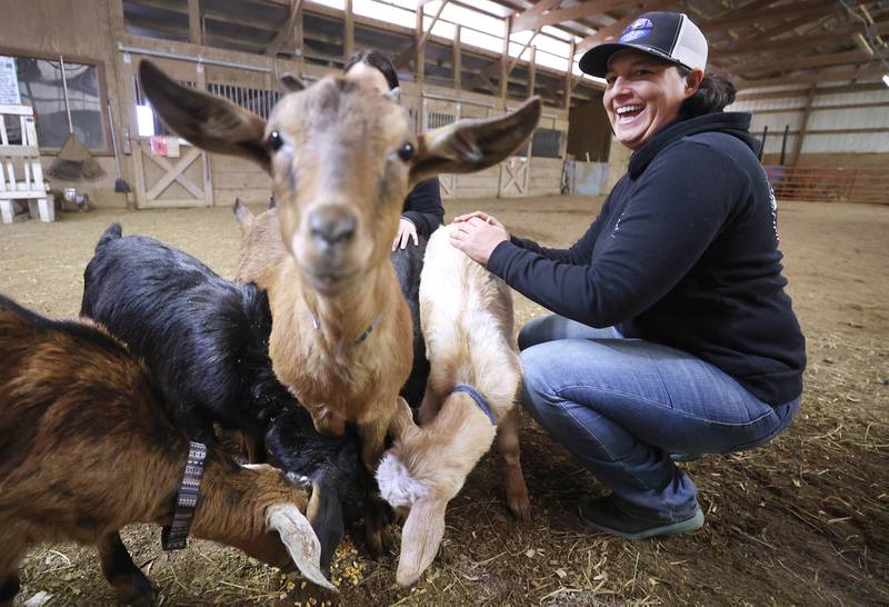 Didi Dowling, owner and executive director of Live, Learn and Lead, pets some of the baby goats Friday, March 31, 2023, at their barn in Hampshire.