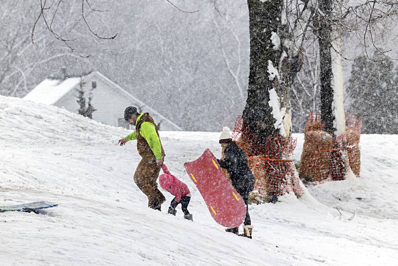 Adam Rodriguez with fiancé Audrey Neuroth and daughter Amelia, 3, climb up the sledding hill at E.C. Smith Park in Dixon Tuesday, Jan. 9, 2024.