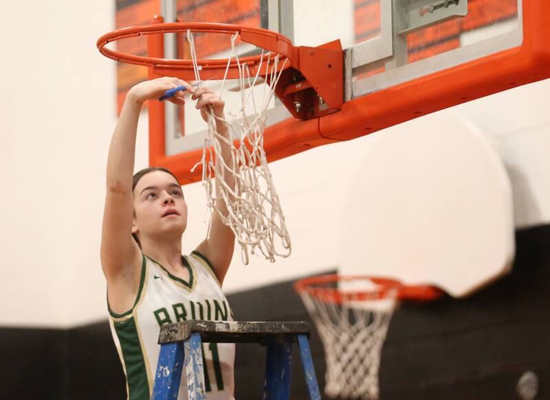 St. Bede's Bailey Engels cuts down a piece of the net after defeating Serena in the Class 1A Sectional final game on Thursday, Feb. 22, 2024 at Gardner-South Wilmington High School.