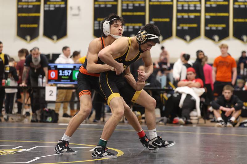 Joseph Pedrosa of Joliet West pulls away from Noah Avina of Minooka for a point in the 120-pound weight SPC Conference championship match at Joliet West on Saturday, Jan 25, 2025.