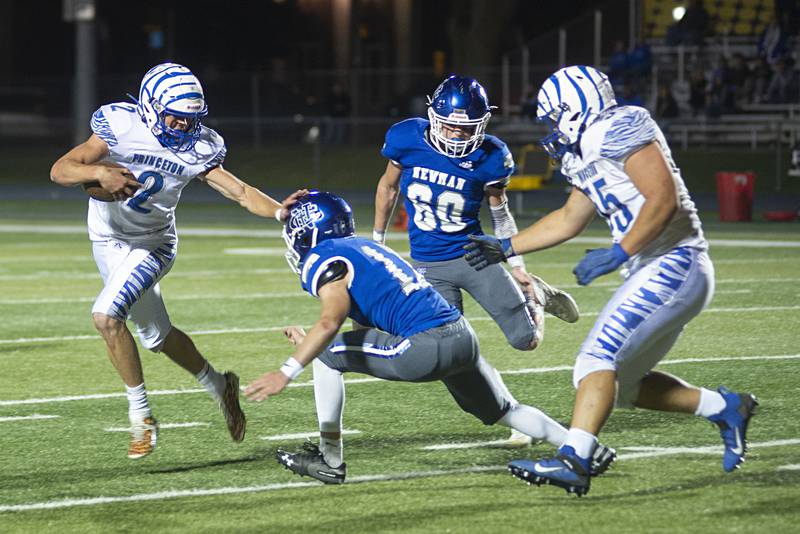 Princeton’s Teegan Davis stiff arms Newman's Gabe Padilla Friday, Sept. 30, 2022.