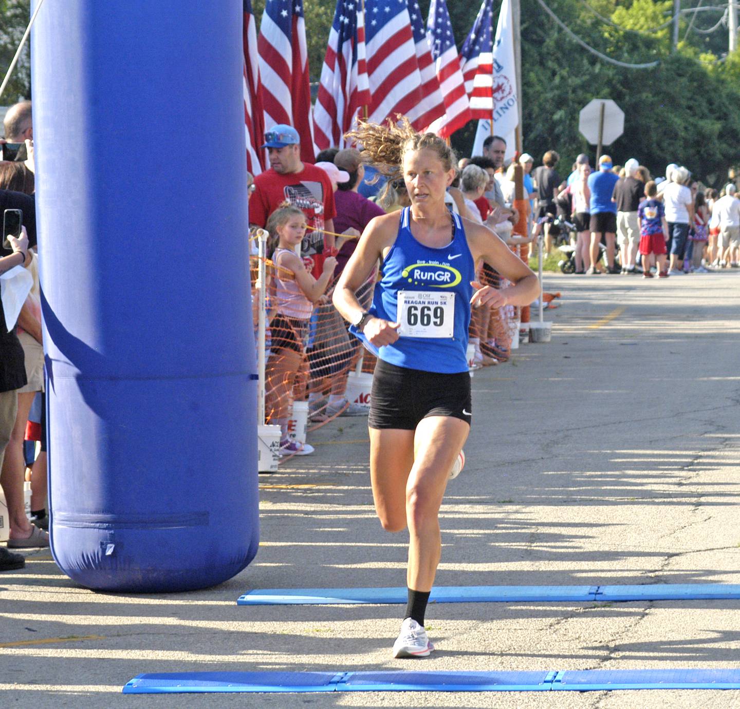 Melissa Winchester of Grand Rapids, Mich., is the first woman across the finish line at the 2025 Reagan Run 5K with a time of 19:15.83.