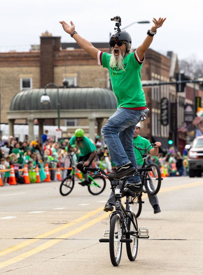 A member of Flat 43 BMX rides down Main Street in St. Charles during the St. Charles St. Patrick’s Parade on Saturday, March 15, 2025.
