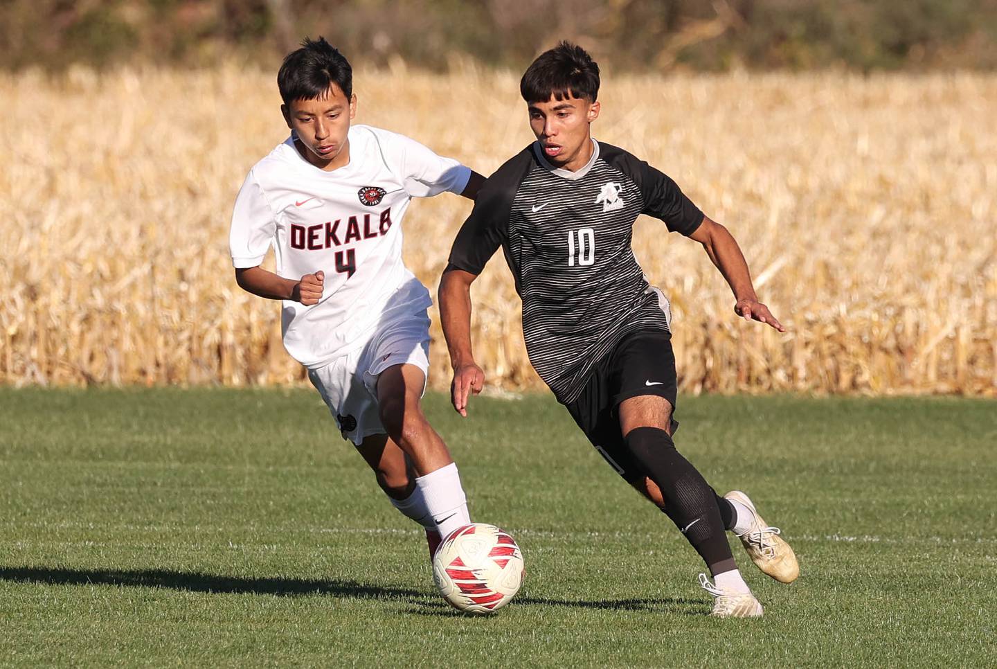 DeKalb's Brandon Cervantes and Kaneland's Jovani Ruiz go after the ball during their game Thursday, Oct. 17, 2024, at Kaneland High School in Maple Park.