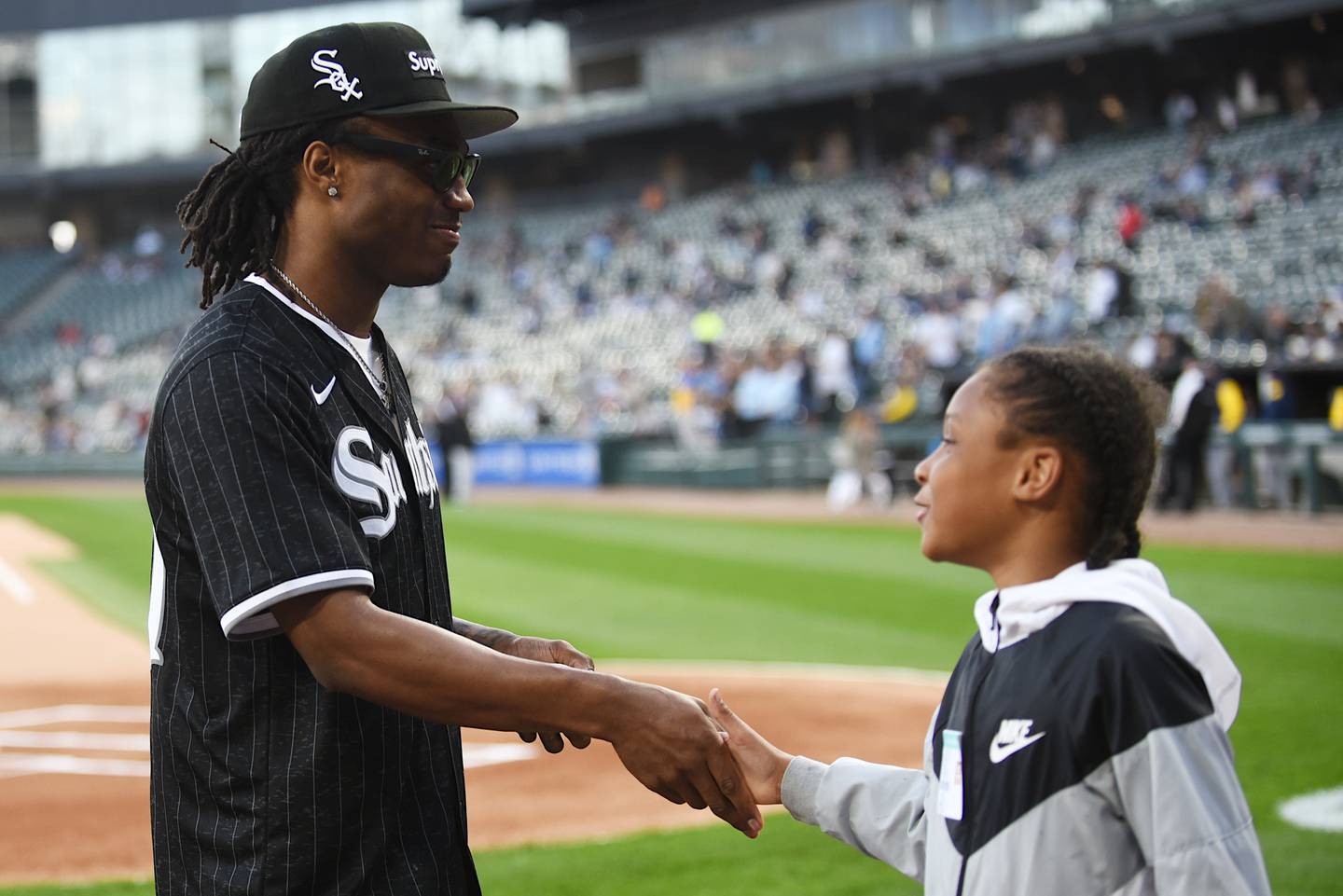Jyaire Hill, left, is congratulated by his brother, Kash, after throwing the ceremonial first pitch before the Chicago White Sox hosted the Milwaukee Brewers at Rate Field in Chicago Tuesday, April 29, 2025.