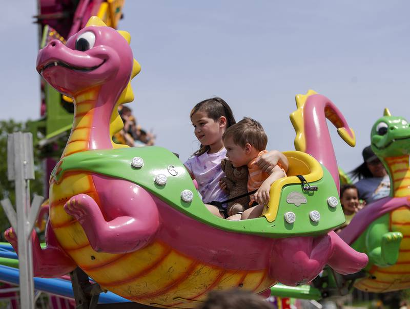 Theo, 2, and Natalie Cedris, 9, of Westmont enjoy a dragon ride during the Spring Fling in Westmont, Ill. on Sunday, May 29, 2022.