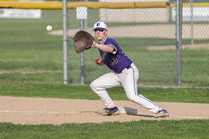 Dixon’s Quentin Seggerbruch catches a ball at first for an out against North Boone Thursday, May 12, 2022.