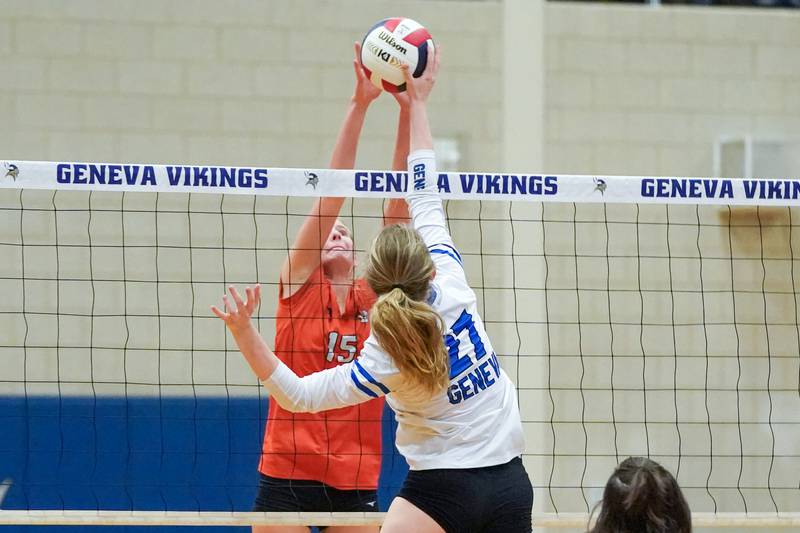 Wheaton Warrenville South's Katie Dragas (15) blocks a kill attempt by Geneva’s Molly Franz (27) during a DuKane Conference match in Geneva on Tuesday, Sept. 16, 2025.