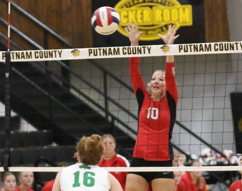Henry-Senachwine's Rachel Eckert jumps in the air to block a spike from Seneca's Brooklyn Sheedy during the Tri-County Conference championship game on Thursday, Oct. 16, 2025 at Putnam County High School.