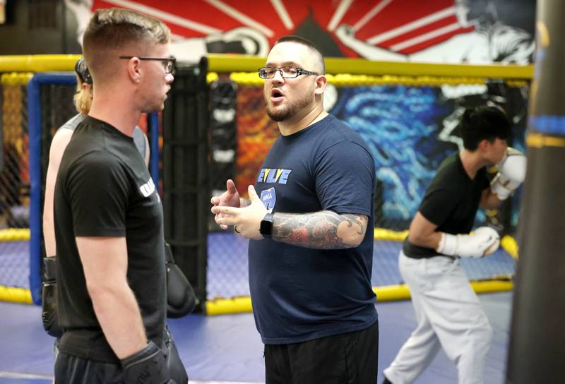 Joe Judkins, head coach at Evolve MMA and Powerlifting, gives some instruction during a class Thursday, Nov. 9, 2023, at the facility in DeKalb.