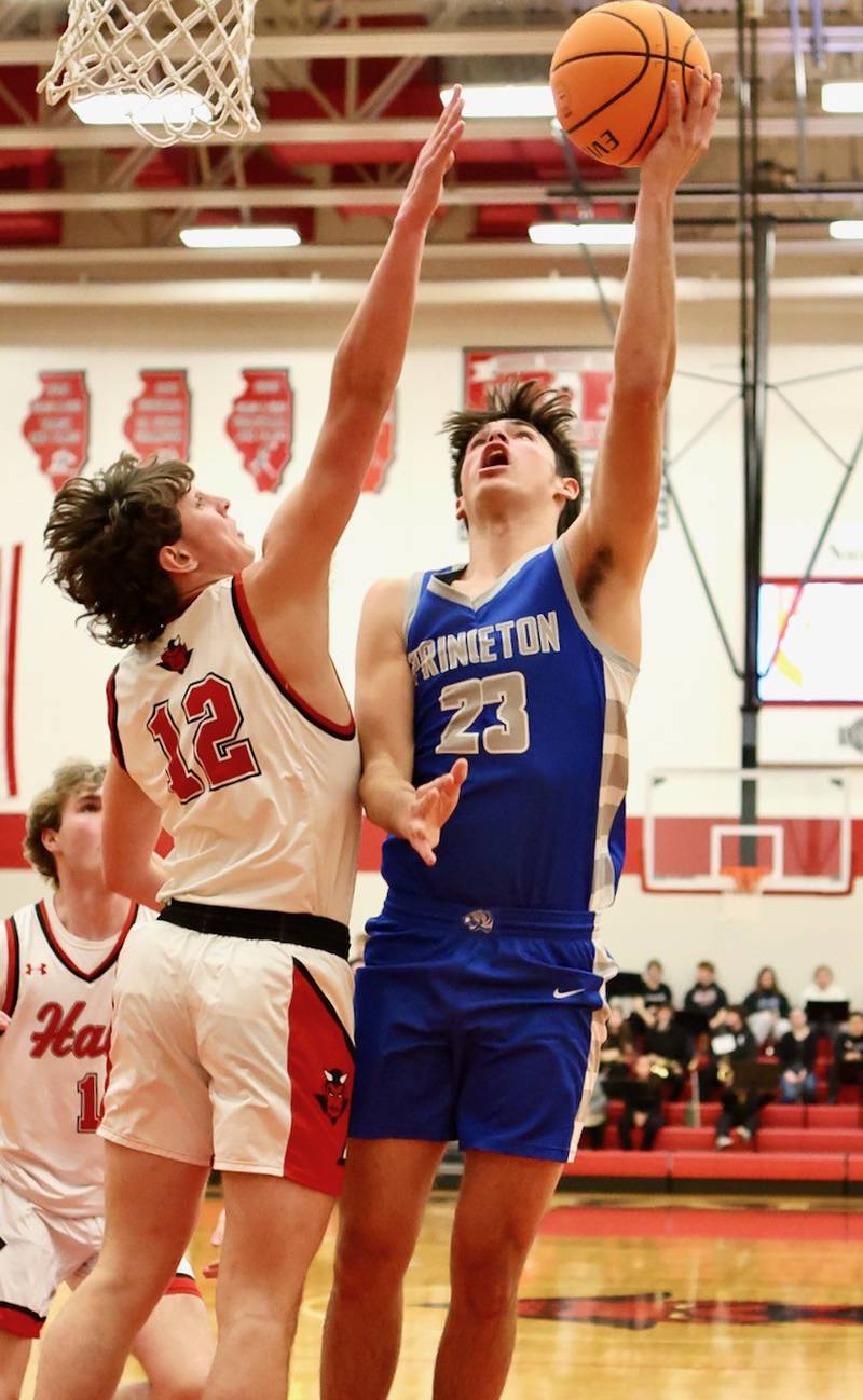 Princeton's Noah LaPorte shoots over Hall's Jack Jablonski Friday night at Hall High School. The Red Devils won 62-54.