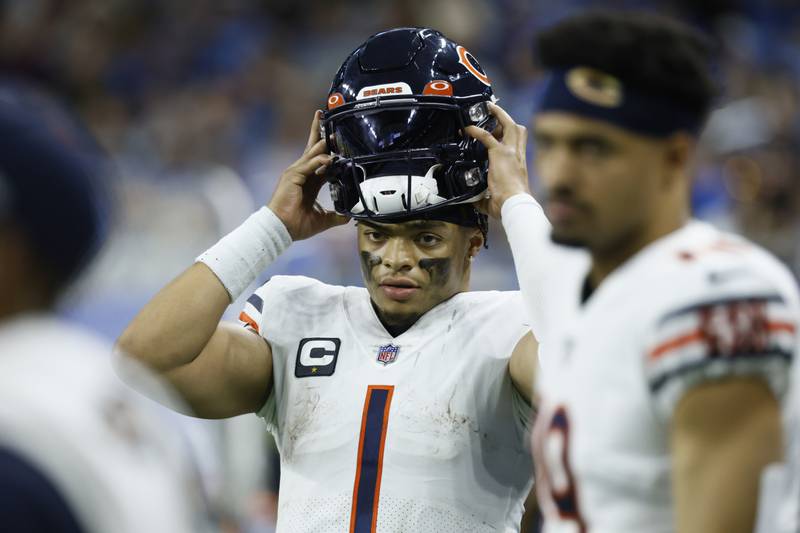 Chicago Bears quarterback Justin Fields puts on his helmet during the second half  against the Detroit Lions, Sunday, Jan. 1, 2023, in Detroit.