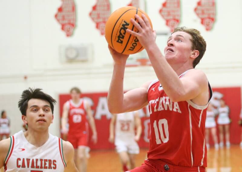 Ottawa's Evan Snook drives to the hoop past L-P's Erick Sotelo to score a bucket on Friday, Feb. 7, 2025 in Sellett Gymnasium at L-P High School.