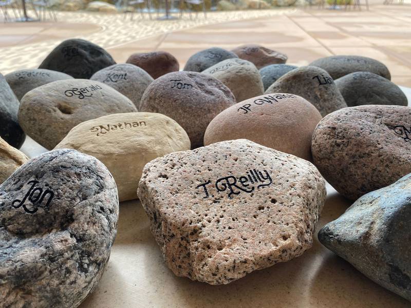 Names of veterans who've died by suicide engraved on 22 rocks are displayed at the inaugural Be the One Walk, a 2.2-mile trek hosted by the DeKalb American Legion Post No. 66 and Legion Auxiliary on Sunday, Sept. 22, 2024. The rocks were carried by walkers. The number 22 symbolizes the average rate that veterans die by suicide each day in the United States. The Be the One campaign is meant to help grow community resources and teach people how to support veterans in crisis.