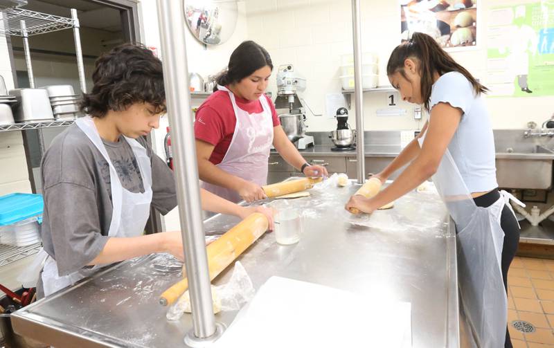 Students roll out dough to make into pasta during the Area Career Center Hands-On Showcase on Thursday, June 8, 2023 at La Salle-Peru Township High School.