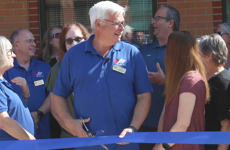 Nate Kloster, executive director at the Voluntary Action Center smiles while cutting the ribbon on the facilities new space on Wednesday, Aug. 13, 2025 in the former Peru Pizza House downtown Peru. VAC is a nonprofit organization committed to serving La Salle, Bureau and Putnam counties through essential programs such as Meals on Wheels and congregate dining.