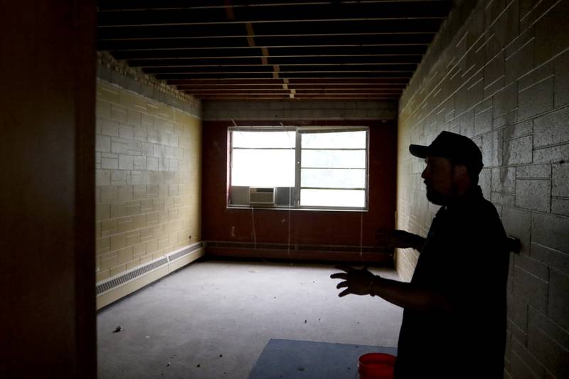 Brent Hollenberg talks about how he is going to make this room into a business center and library in the Ridgefield schoolhouse at 8617 Ridgefield Road, near Crystal Lake, on Wednesday, May 21, 2025. Hollenberg plans to turn the schoolhouse into a six-unit Airbnb. The building was last the home of the McHenry County Jewish Congregation.