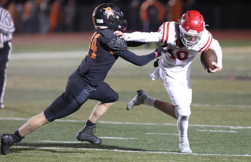Naperville Central's Chris McCormack tries to get by DeKalb's Nathan Smith during their game Friday Oct. 7, 2022, at DeKalb High School.