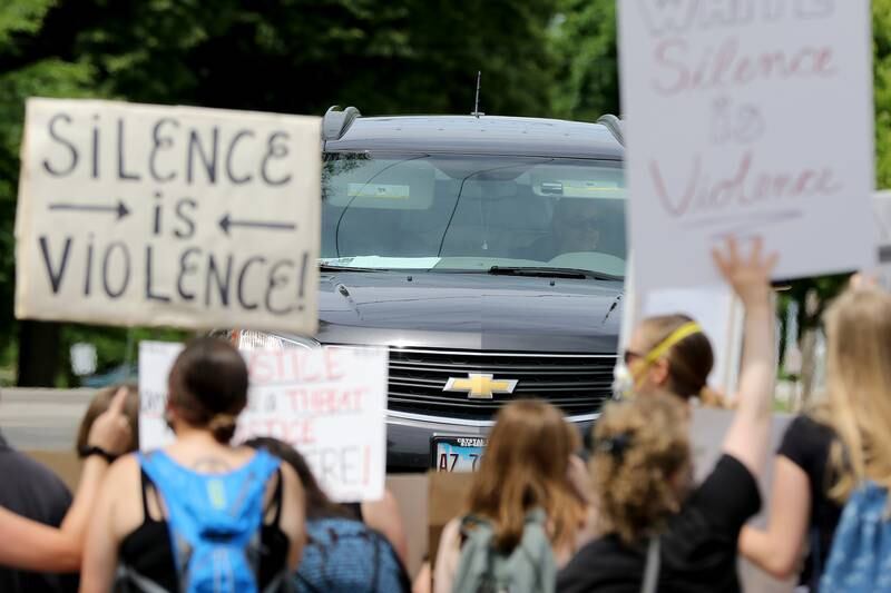 Cars are blocked by protesters in the crosswalk during a Black Lives Matter protest on Friday, June 5, 2020 in downtown Crystal Lake. More than a hundred peaceful protesters stood and chanted with signs for two hours at the 5-way stop intersection of Walkup Ave, Crystal Lake Ave, and Grant St. Every 20 minutes, the group moved into the crosswalks to block traffic for 7 minutes to raise awareness for the social injustices faced by African American people across the country. Protesters marched peacefully but vocally down Grant St and East Woodstock St to Depot Park to listen to speakers share their experiences and offer ideas to help society battle racism.