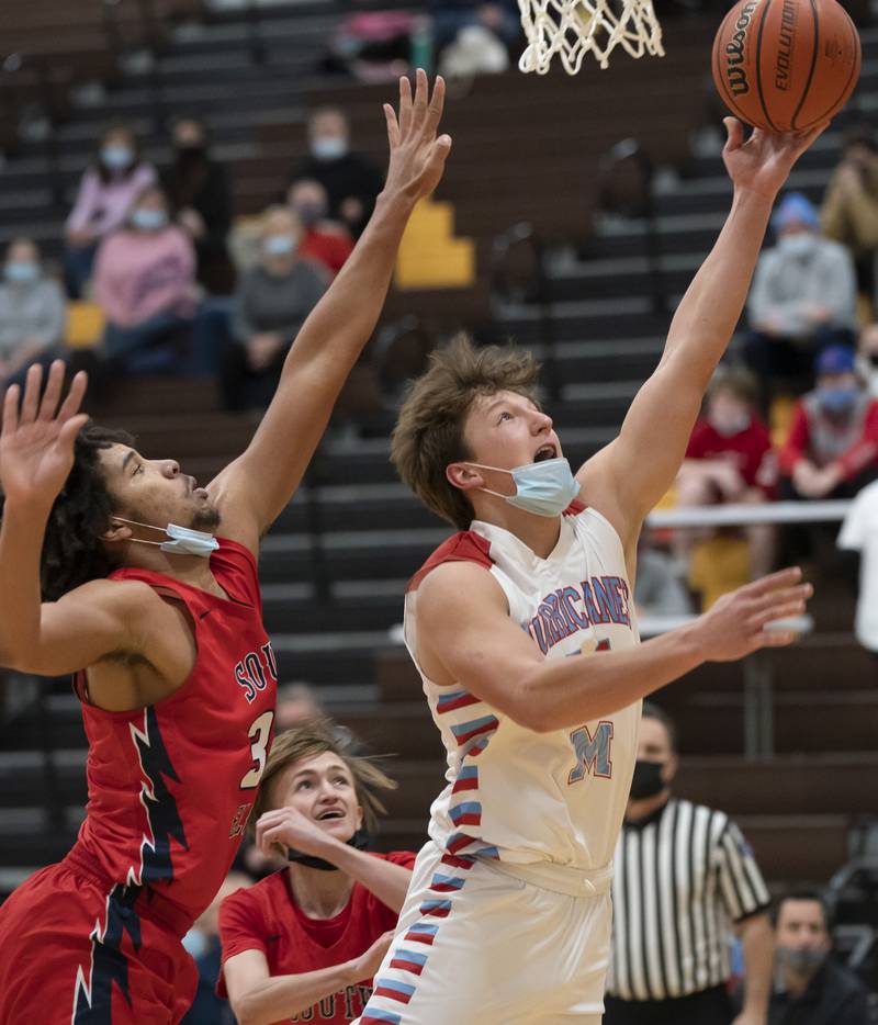 Marian Central's Christian Bentancur shoots over South Elgin's Kendis Wiley during their game at the Hinkle Holiday Classic basketball tournament on Monday, December 27, 2021 at Jacobs High School in Algonquin.