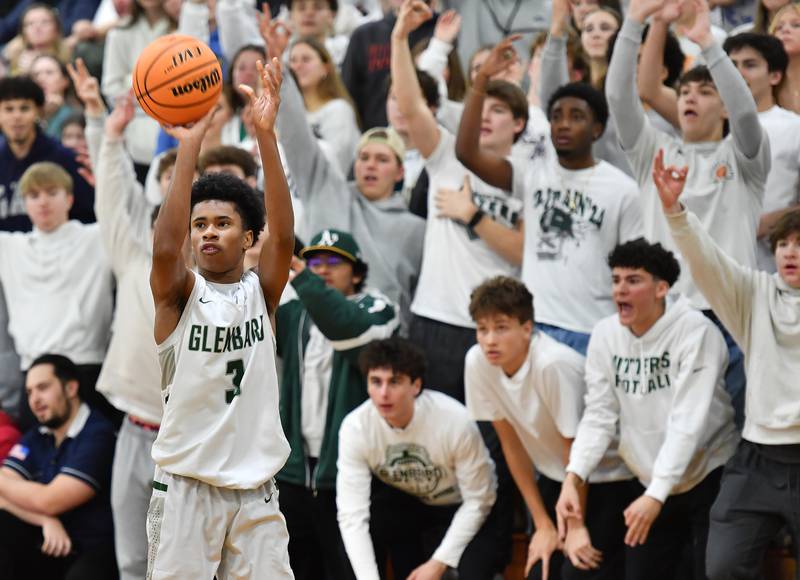 Hinsdale Central’s Dillon Orozco (2) ties up Glenbard West’s Teyion Oriental (11) during a game on January 31, 2025 at Glenbard West High School in Glen Ellyn.