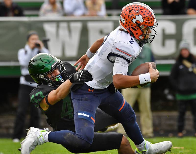 Glenbard West's Xavier Nixon (43) sacks Naperville North quarterback Jacob Bell (2) during an IHSA Class 8A playoff game on Oct. 28, 2023 at Glenbard West High School in Glen Ellyn.