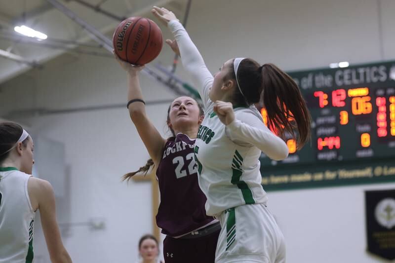 Lockport’s Kara Osinski takes the contested shot against Providence.