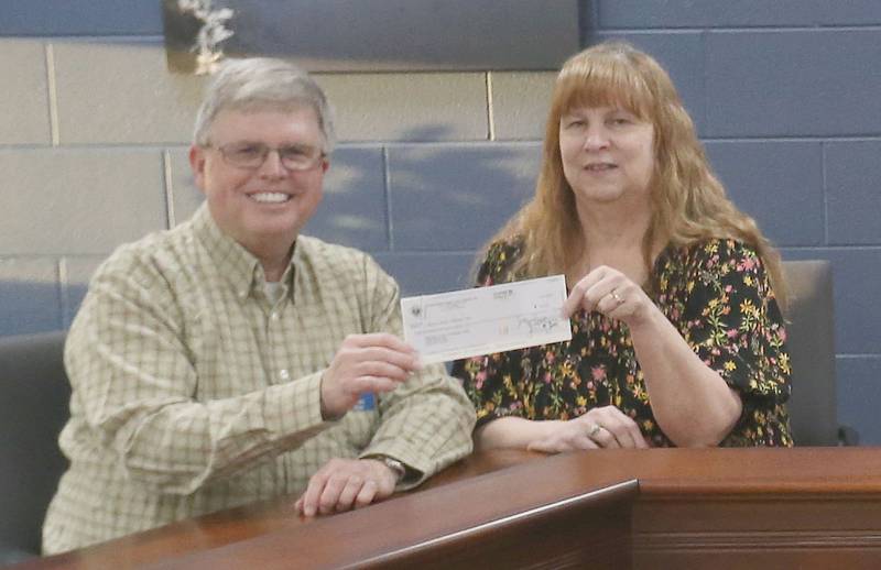 The Utica Knights of Columbus donated $2,600 to four local charities in the Illinois Valley on Thursday, March 18, 2026 at the Utica Village Hall.  Pictured here are Ed Brown, grand knight and Alice Buczkowski, administrative assistant for Horizon House. Other organizations at the check passing were Starved Rock Regional Center, Special Olympics and Lighted Way. The money was donated through The Knights of Columbus Intellectual Disabilities Fund Drive, commonly known as the Tootsie Roll Drive, last October. The fund drive supports local programs for people with special needs. Each organization received $650.
