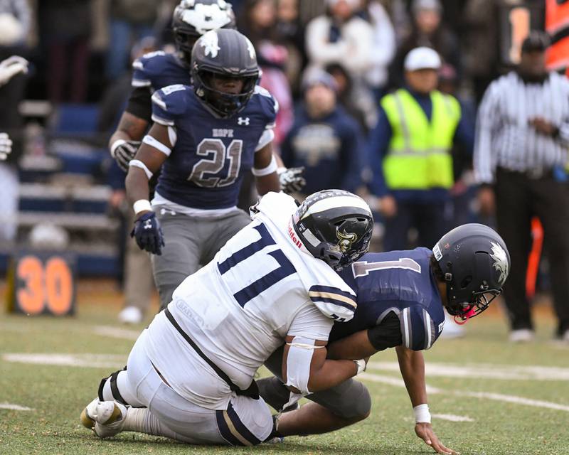 IC Catholic Prep's Josh Shaw (77) tackles Chicago Hope Academy’s Daevion Greenberg (1) during the 3A Playoff game against Chicago Hope Academy on Saturday Nov. 1, 2025, held at Altgeld Park in Chicago.