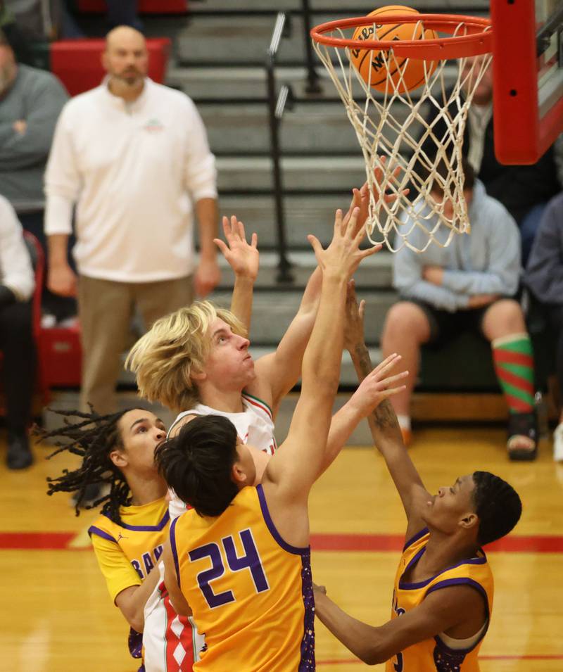 L-P's Mason Morscheiser lets go of the ball underneath the hoop while scoring against Rantoul defenders on Friday, Dec. 19, 2025 in Sellett Gymnasium at L-P High School.