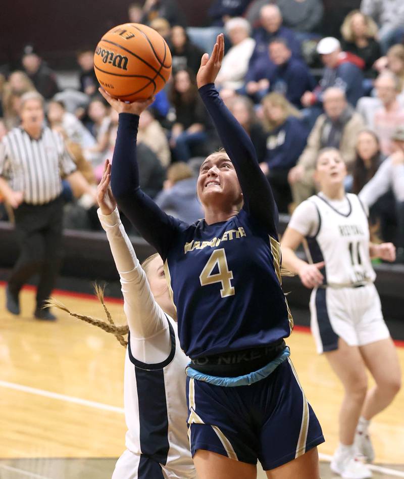 Marquette's Hunter Hopkins shoots the ball in front of Rockford Christian's Ava Reese Tuesday, Feb 24, 2026, during their Class 1A sectional semifinal game at Indian Creek High School in Shabbona.