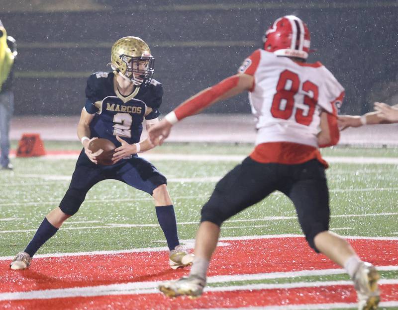 Polo quarterback Jt Stephenson, looks to run the ball as Amboy/LaMoille/Ohio's Evan Flanagan runs toward him during the 8-man I8FA championship game on Friday, Nov. 21, 2025 at April Zorn Memorial Stadium in Monmouth.