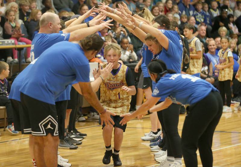 Liam Jones , a sixth-grade student at Logan Jr. High School, runs through a tunnel of teachers during the Harlem Wizards event on Tuesday, Oct. 28, 2025 in Pannebaker Gymnasium at Logan Jr. High School in Princeton.
