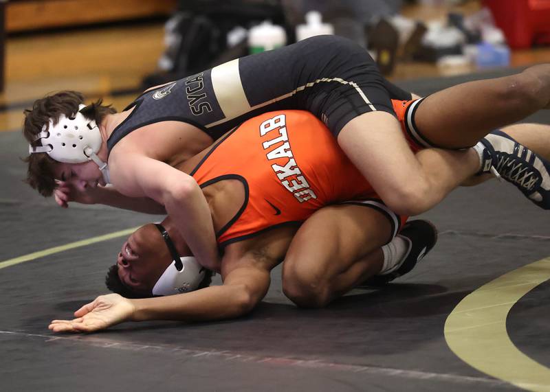 Sycamore’s Charlie Olson controls DeKalb’s Brennan McCarter during their 132 pounds match Friday, Jan. 16, 2026, at Sycamore High School.