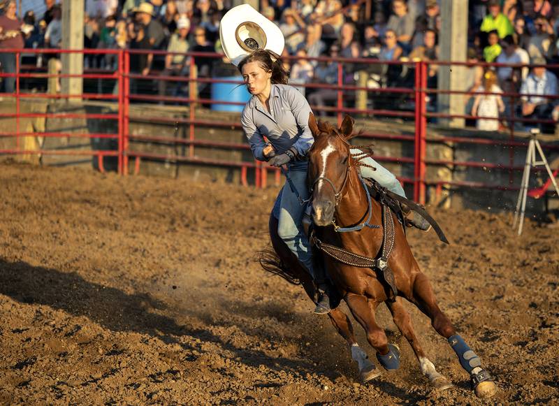 Albie Jo Hartman loses her hat during her run in the barrel racing event Thursday, August 7, 2025, at Carroll County Fair’s T and A Bucking Bulls Rodeo.
