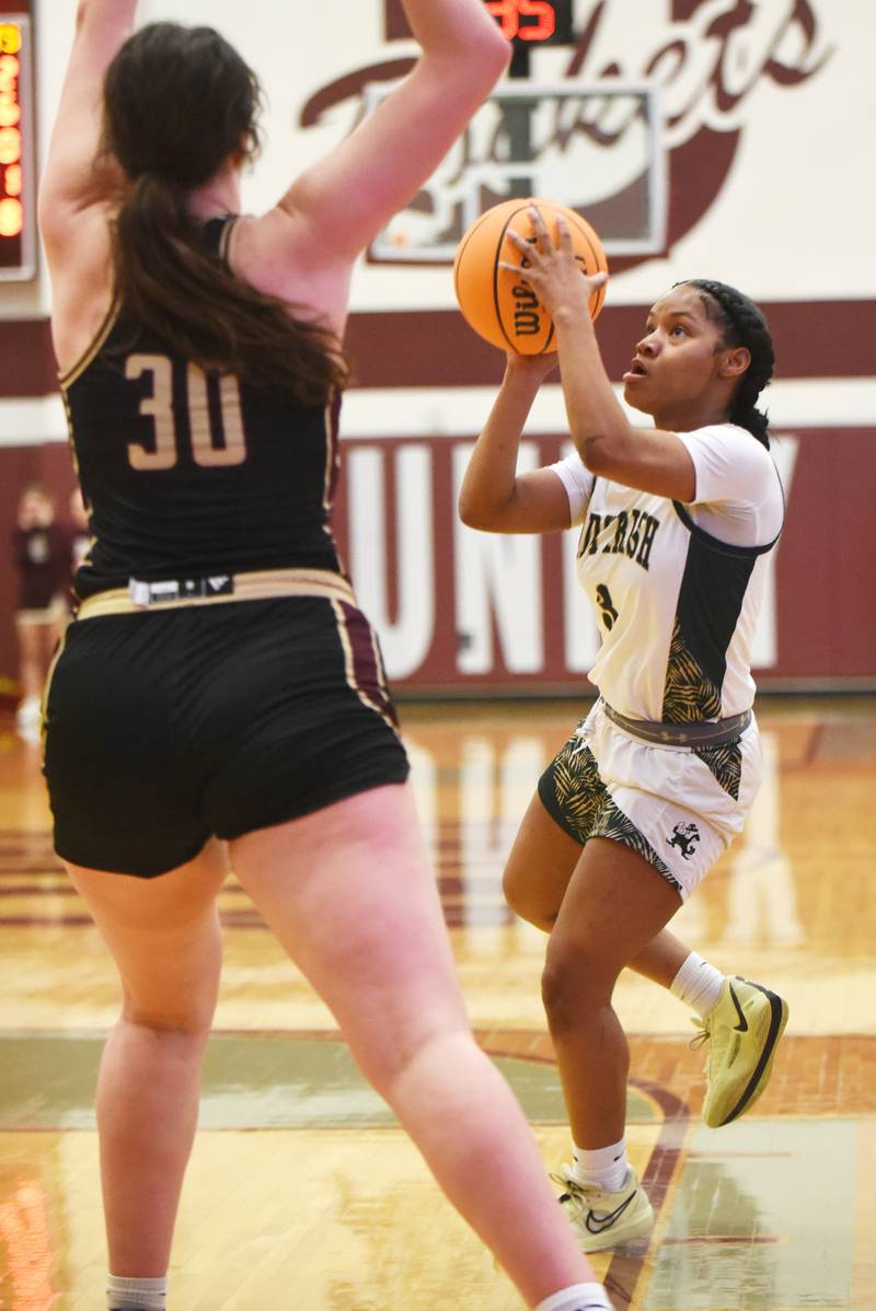 Bishop McNamara's Eliana Ison, right, looks to shoot over Mt. Carmel's Maycee Randall during the IHSA Class 2A Tolono Unity Super-Sectional Monday, March 3, 2025.