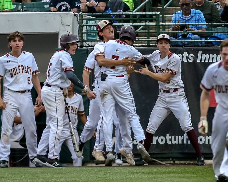 St. Ignatius Aaron Stuart (7) is greeted by teammates after scoring a run during the Class 3A Crestwood Supersectional game between St. Ignatius at Nazareth.  June 6, 2022.