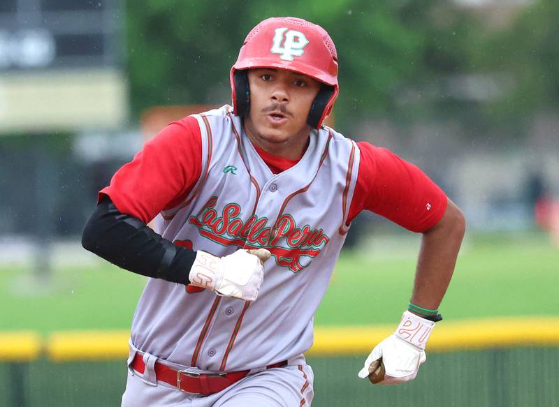 LaSalle-Peru's Monti Lorenzi hustles to third Tuesday, May 12, 2026, during their game at Kaneland High School in Maple Park.