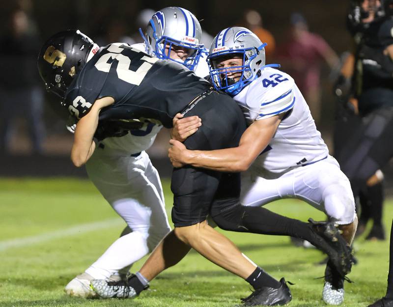 Woodstock's Zachary Canaday (right) and Stewart Reuter bring down Sycamore's Dylan Hodges during their game Friday, Sept. 8, 2023, at Sycamore High School.