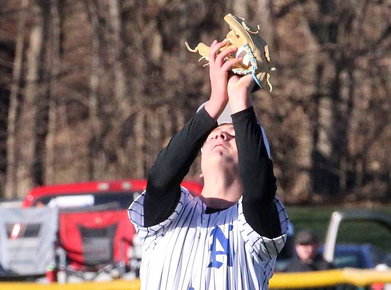 Newark's Jimmy Kath squeezes the ball for an out against Marquette on Monday, March 23, 2026 at Newark High School.