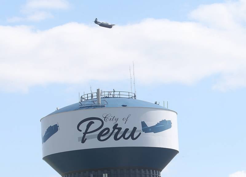 A TBM aircraft flies over the Peru water tower during the 10th annual TBM Reunion and Airshow on Saturday, May 17, 2025 in Peru.