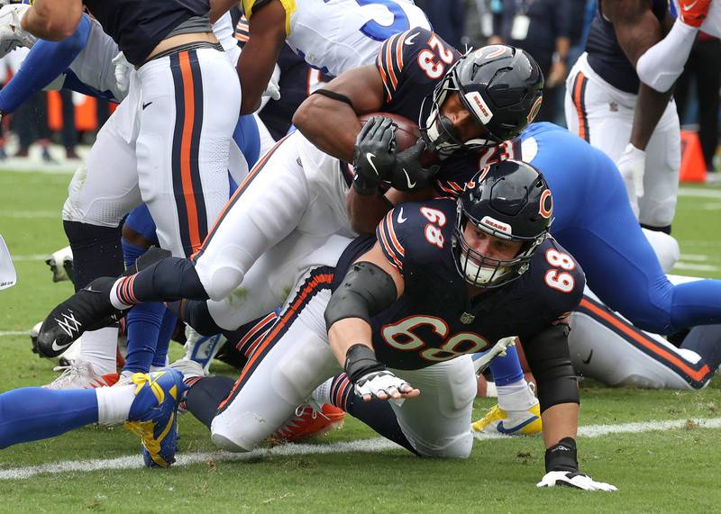 Chicago Bears running back Roschon Johnson dives over Chicago Bears center Doug Kramer Jr. for a touchdown late in the first half of their game against the Los Angeles Rams Sunday, Sept. 29, 2024, at Soldier Field in Chicago.