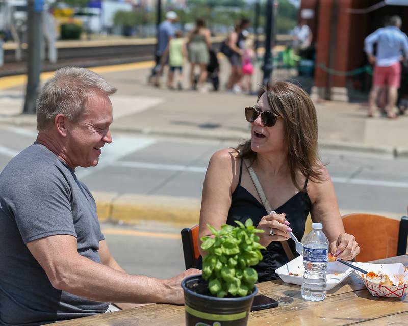 Mark and Janel enjoy a meal at D'Capo's at the Downers Grove Rotary GroveFest in downtown Downers Grove. June 24, 2023.